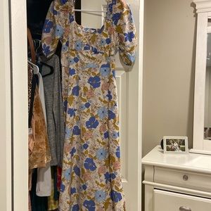 Floral dress. Cuts around ankle. Puff sleeve